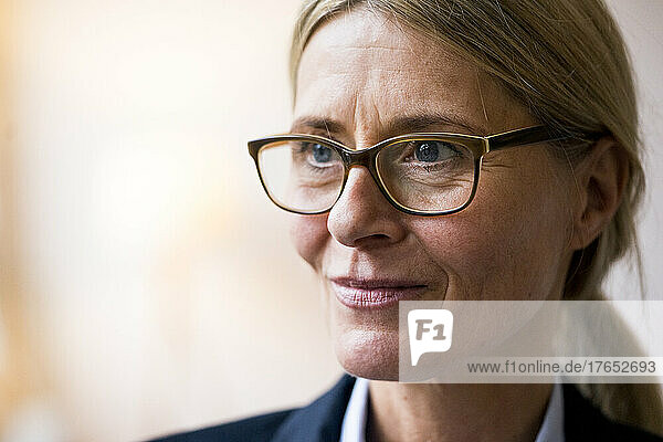 Contemplative mature woman with eyeglasses