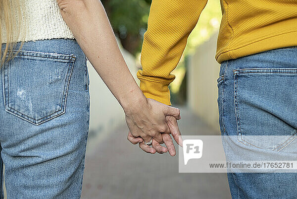 Heterosexual couple holding hands