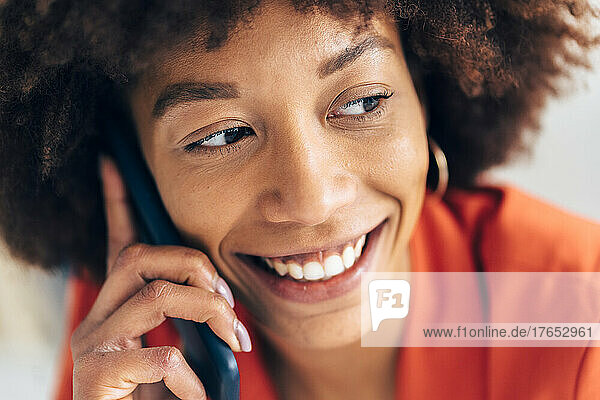 Lächelnde Geschäftsfrau  die am Handy spricht