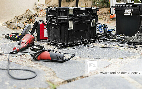 Construction work tools and toolbox on footpath