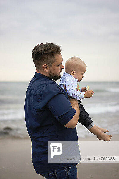 Vater und Sohn stehen am Strand