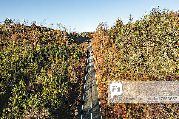 UK  Wales  Aerial view of highway stretching across autumn landscape of Snowdonia National Park