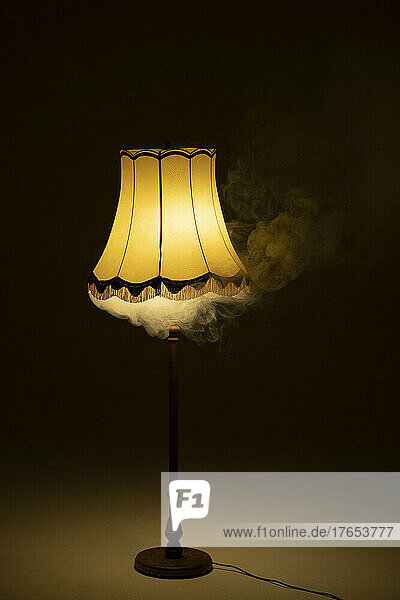 Illuminated smoky lamp in dark room