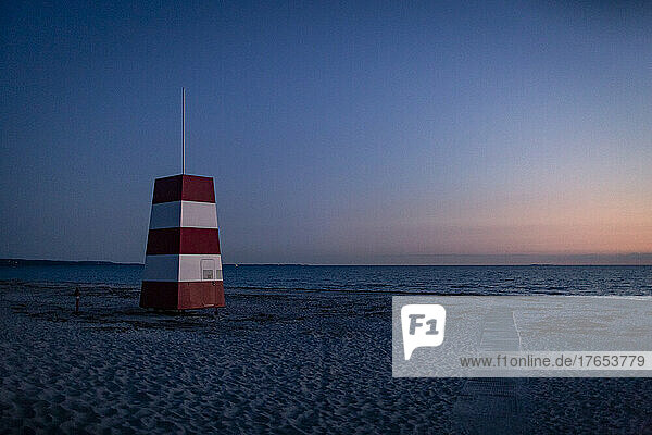 Lifeguard tower on beach at dusk
