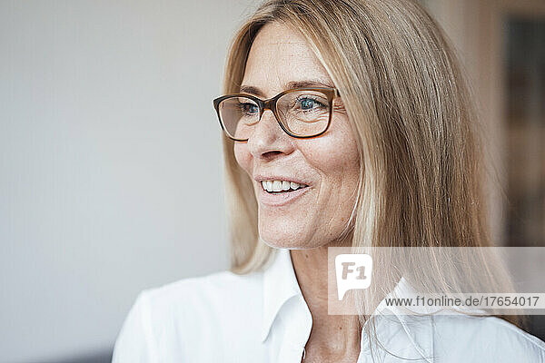 Smiling mature woman with eyeglasses at work place
