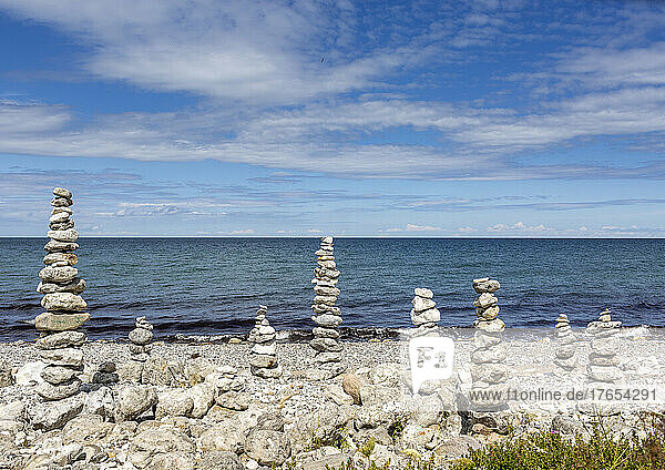 Stack of stones at beach on sunny day