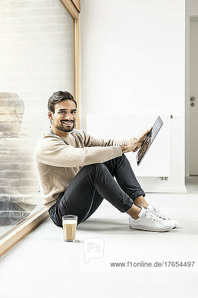 Young man with tablet PC sitting at home