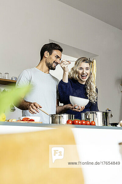 Couple preparing food in kitchen at home