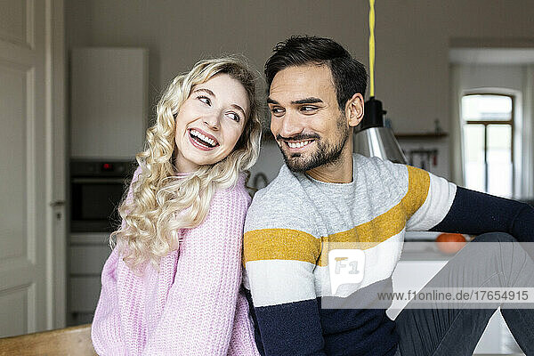 Blond woman sitting with boyfriend at home