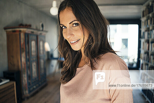 Smiling beautiful woman with brown hair at home