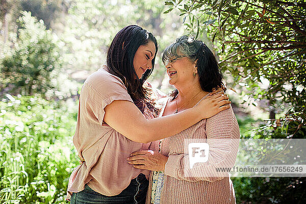 Mother & Daughter Embracing in Park in San Diego