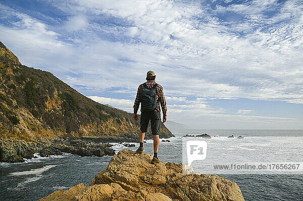 Male posing on the coast at Partington Cove in Big Sur California