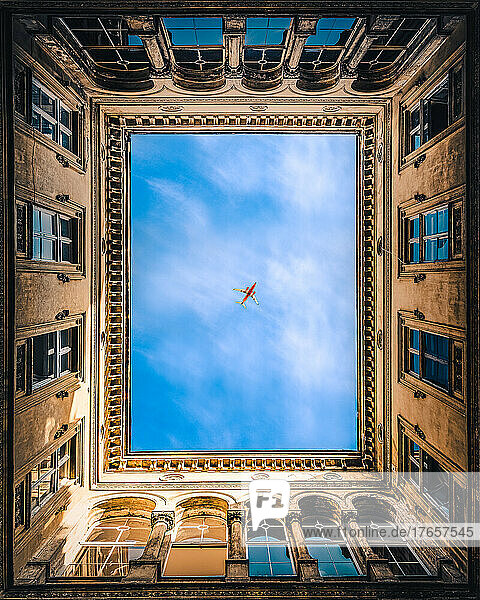 Airplane framed by buildings in Budapest  Hungary