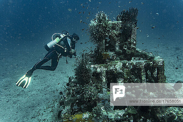diver exploring underwater structure in Bali