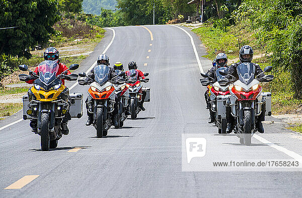 group of bikers riding on road in northern Thailand