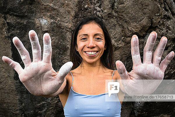 A rock climber girl shows her hands after a climbing day