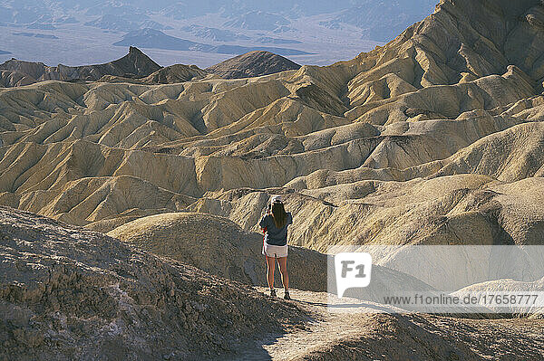 Female taking photo at Zabriskie Point in Death Valley National Park