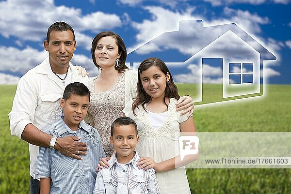 Happy hispanic family standing in graß field with ghosted house behind