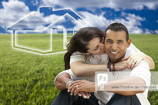 Happy hispanic couple sitting in grass field with ghosted house figure behind them