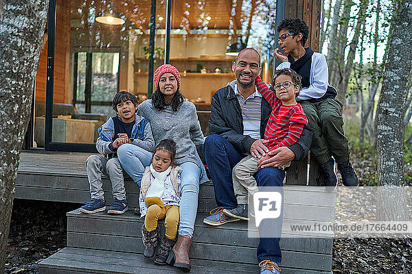 Portrait happy family on house rental steps