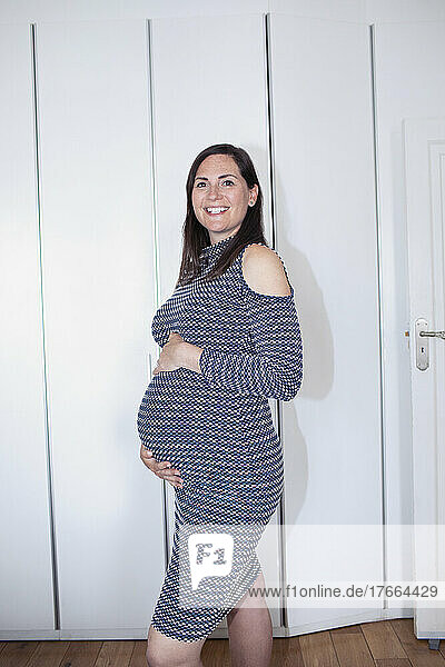 Portrait smiling pregnant woman in dress