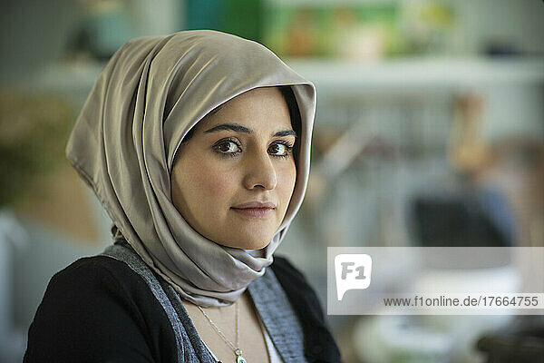 Portrait confident beautiful young Muslim woman in hijab