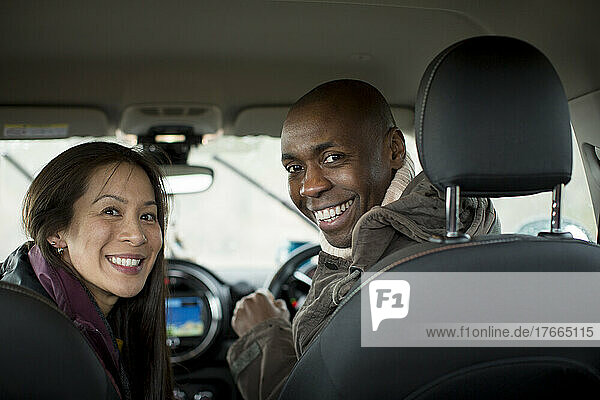 Portrait happy couple inside car