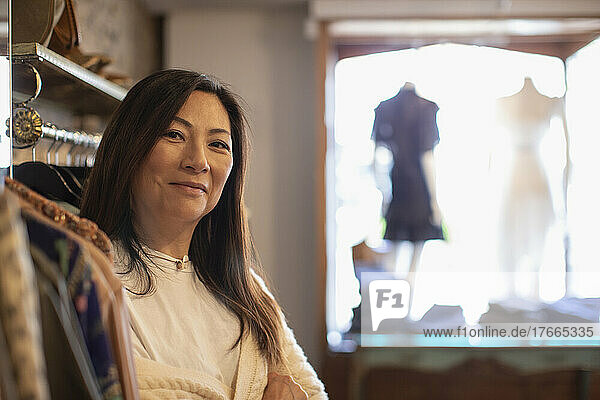 Portrait confident female shop owner in clothing boutique