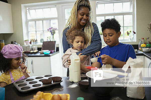 Mother and kids baking in kitchen