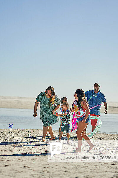 Happy family playing on sunny beach