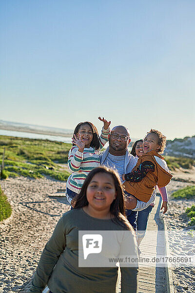 Happy family on sunny beach boardwalk