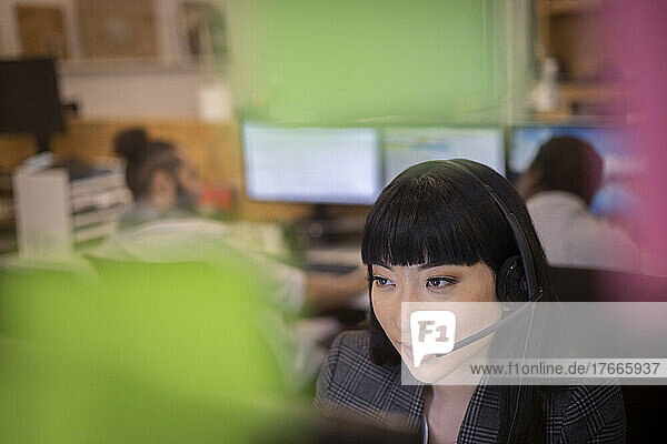 Businesswoman in headset working in office