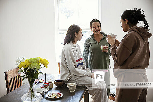 Mother and daughters talking in morning dining room
