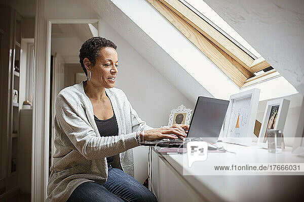 Mature woman working from home at laptop