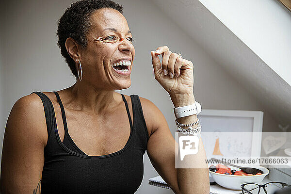 Happy mature woman laughing and looking away