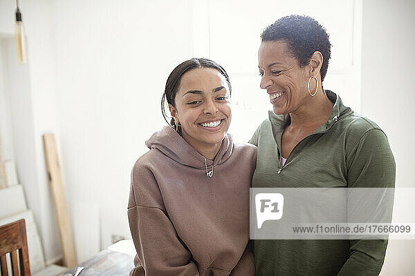 Happy mother and daughter in sweatshirts
