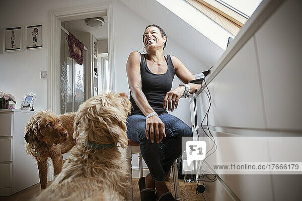 Dogs and happy woman in home office