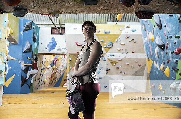 Confident young woman at climbing center