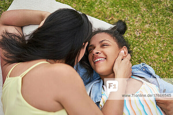 Happy  affectionate mother and disabled daughter laughing in park
