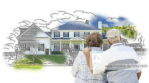 Curious embracing senior couple looking at house drawing and photo combination on white