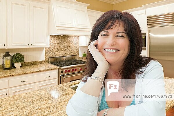 Attractive middle aged woman portrait inside kitchen at home