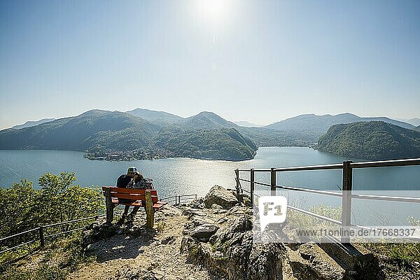 Viewpoint with couple on a bench  Sasso Delle Parole  near Lugano  Lake Lugano  Lago di Lugano  Ticino  Switzerland  Europe