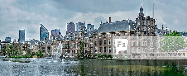 Panorama of the Binnenhof House of Parliament and the Hofvijver lake with downtown skyscrapers in background  The Hague  Netherlands
