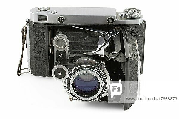 Old folding camera before white background