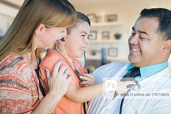 Young boy and mother visiting with hispanic doctor in office
