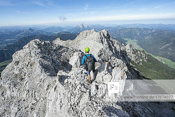 Hiker in rocky terrain  ascent to Mitterhorn  mountain panorama  rocky ridge with peaks Östliches Rothorn and Großes Rothorn in the background  Nuaracher Höhenweg  Loferer Steinberge  Tyrol  Austria  Europe