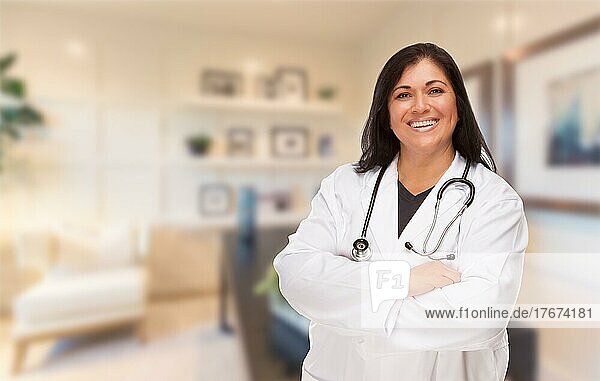 Female hispanic doctor or nurse standing in her office