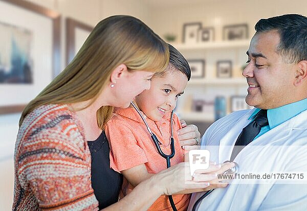 Young boy and mother visiting with hispanic doctor in office