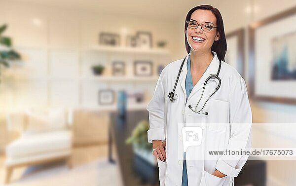 Young female doctor or nurse standing in her office