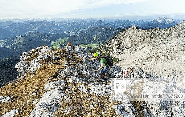 Hiker with climbing helmet  climbing the Mitterhorn  view of mountain landscape  Nuaracher Höhenweg  Loferer Steinberge  Tyrol  Austria  Europe